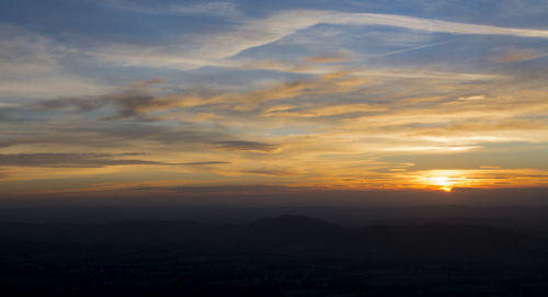 Scenic view of silhouette mountains against sky during sunset