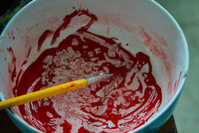 High angle view of paintbrushes in bowl