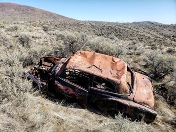 Abandoned vintage car on field