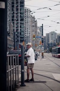 Full length rear view of man walking in city