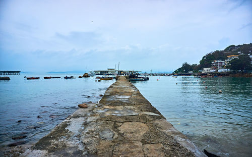 Pier on sea against sky