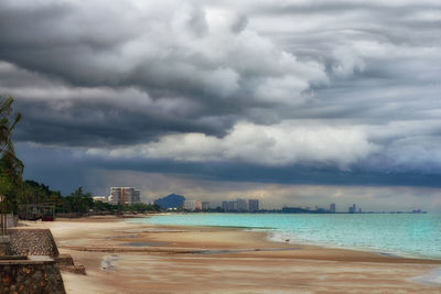 View of beach against cloudy sky