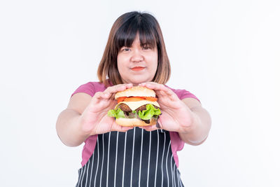 Portrait of mid adult woman against white background