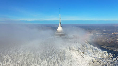 Aerial view of city against blue sky