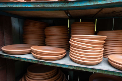 Stack of earthenware in shelf on table