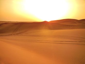 Scenic view of desert against sky during sunset