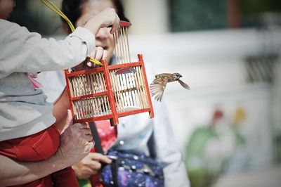 Family releasing bird from cage