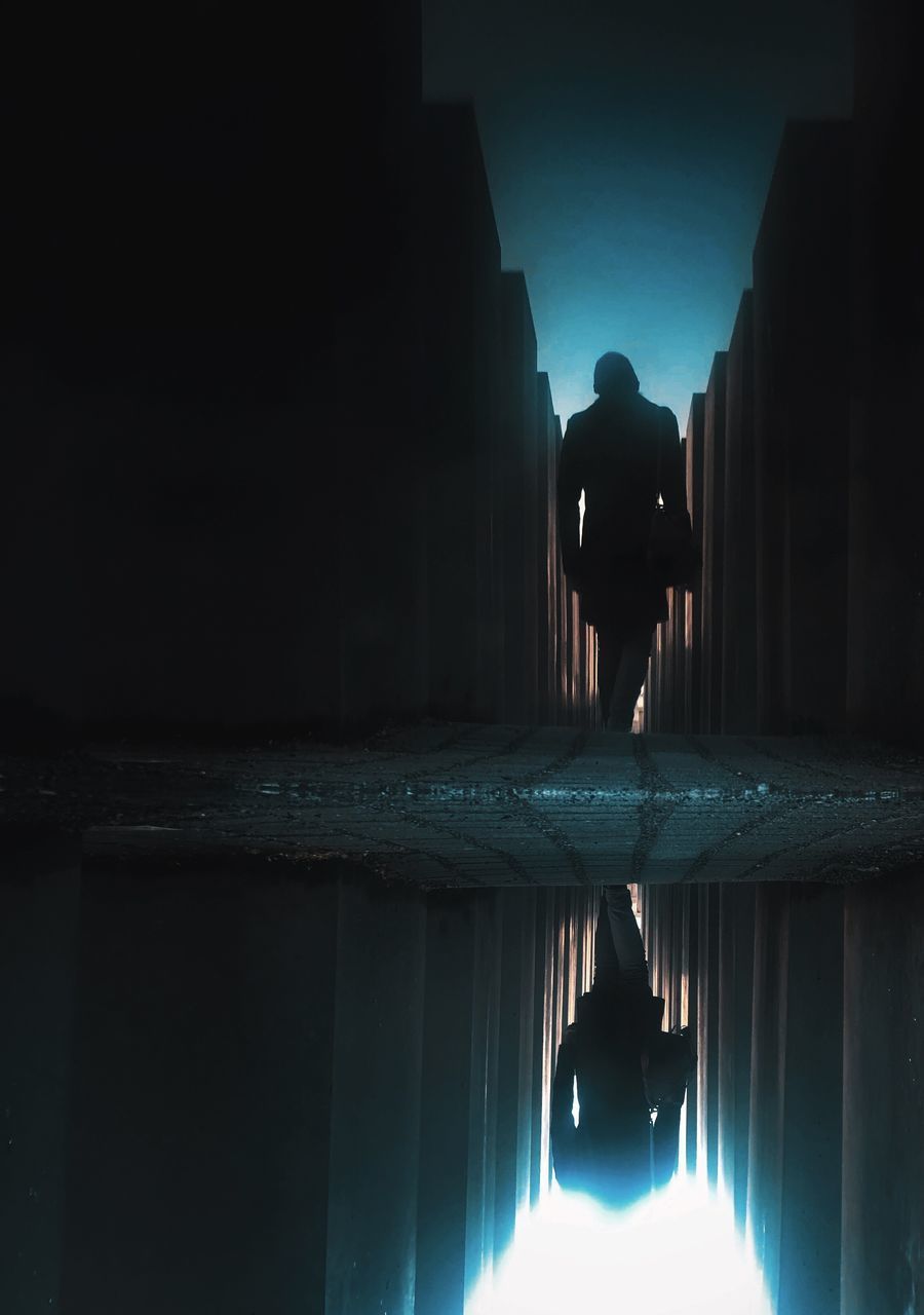 REAR VIEW OF SILHOUETTE MAN STANDING IN SWIMMING POOL