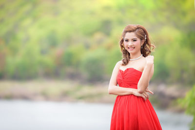 Portrait of young woman standing outdoors