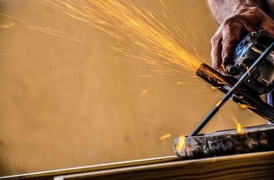 View of worker welding in factory