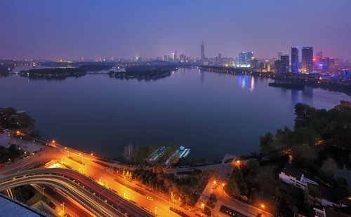 High angle view of city lit up at night