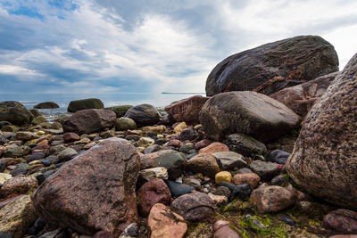 Rocks by sea against sky