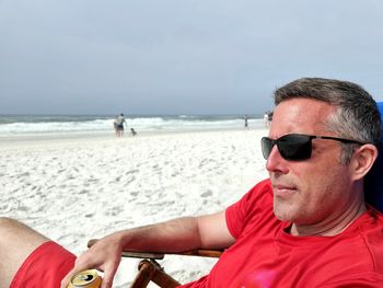 Portrait of man sitting at beach