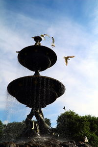 Low angle view of bird flying against sky