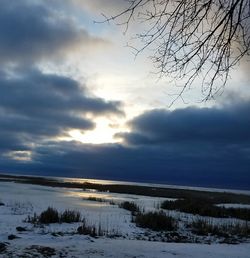 Scenic view of snow against sky at sunset
