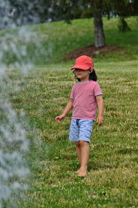 Full length of girl standing on field