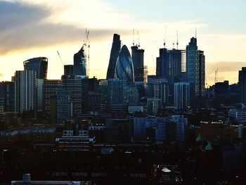 View of skyscrapers against cloudy sky