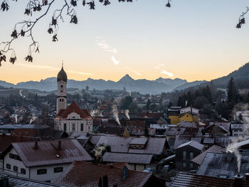 Aerial view of townscape against sky at sunset