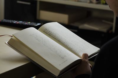 Close-up of hand on book