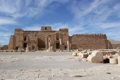 Old ruins of temple against cloudy sky