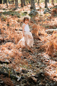 Portrait of girl standing in forest