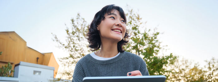 Young woman using digital tablet