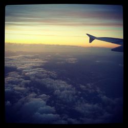 Cropped image of airplane flying over landscape