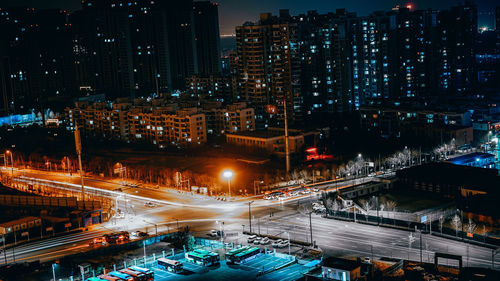 High angle view of illuminated buildings in city at night