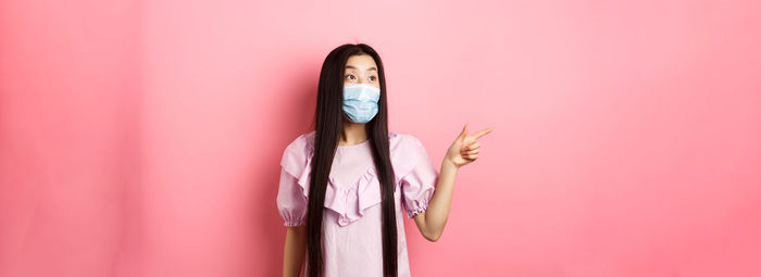 Low section of woman standing against yellow background