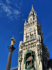 Low angle view of statue against blue sky