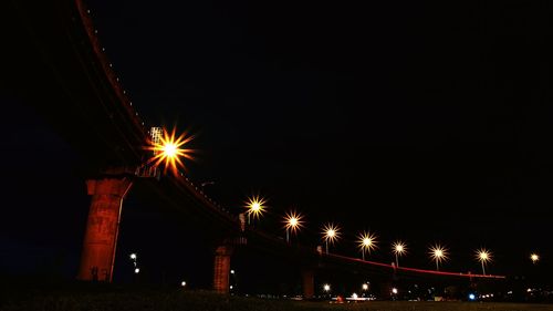 Low angle view of illuminated street light against sky at night