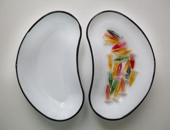 High angle view of candies in plate on table