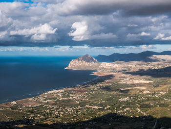 Scenic view of sea and mountains against sky