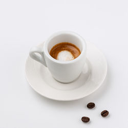 Close-up of coffee cup over white background