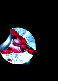 Close-up of red object over black background