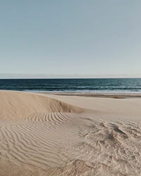 Scenic view of beach against clear sky