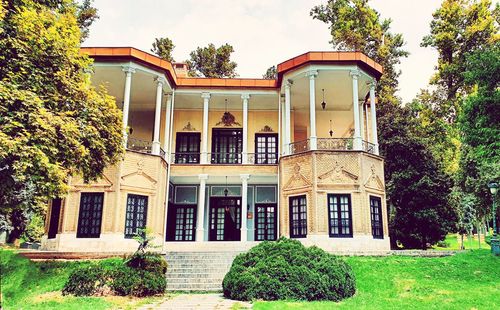 Facade of house and building against sky