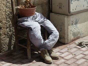 Low section of man standing by wall