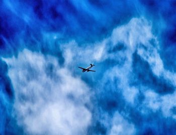 Low angle view of airplane flying in sky