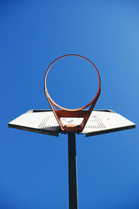 Low angle view of basketball hoop against clear blue sky