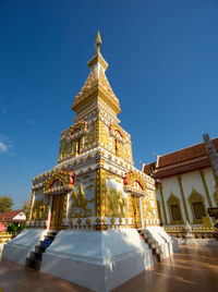 Low angle view of illuminated building against clear blue sky