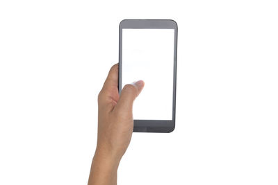 Midsection of person holding mobile phone against white background