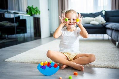 Portrait of young woman exercising on table