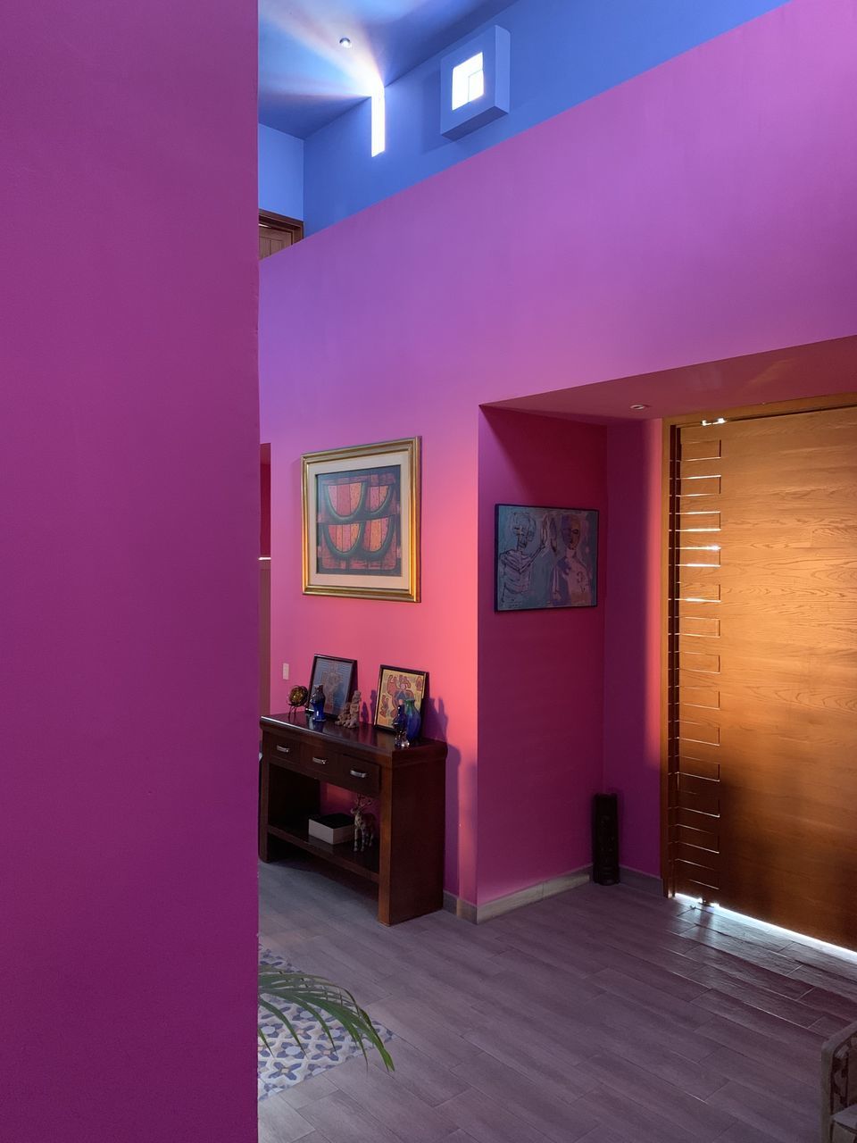 INTERIOR OF EMPTY ROOM WITH PINK WALL AND PURPLE DOOR