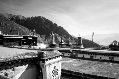 Bridge by mountain against sky