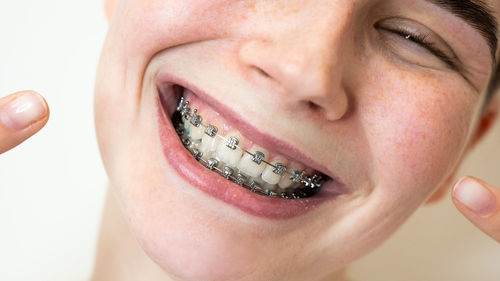 Close-up of young woman holding lips