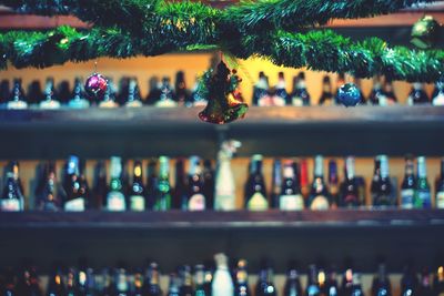 Close-up of christmas decoration with bottles in background