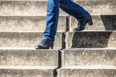 Low section of woman moving down on steps