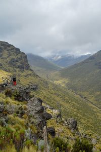 A hiker in the panoramic mountain landscapes of mount kenya, kenya