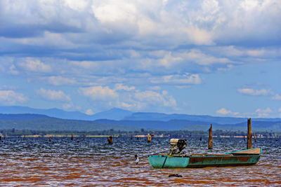 Boats moored in sea against sky